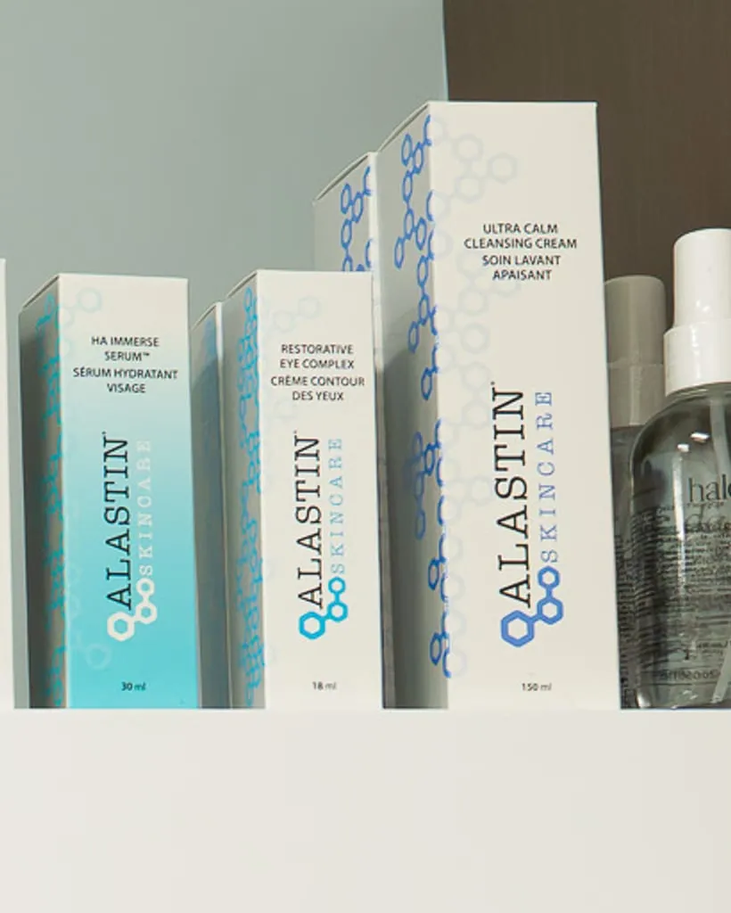 Cleansing products and a spray bottle on a clinic shelf